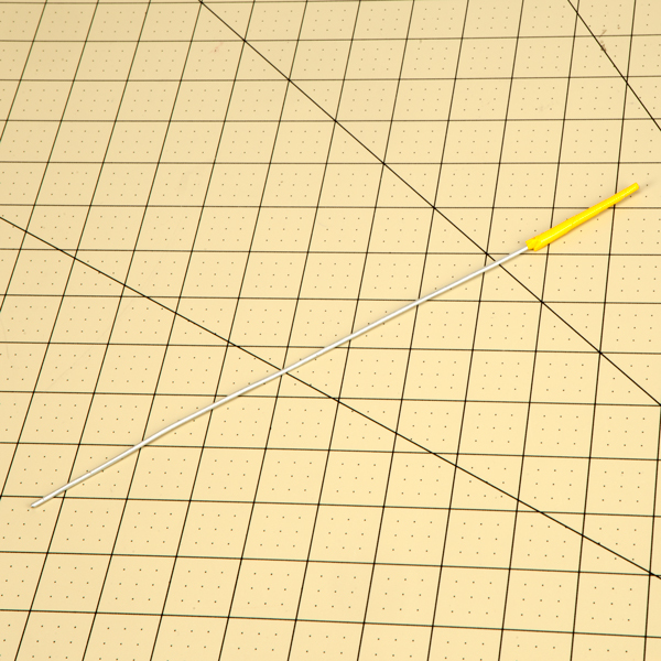 Triangle from previous step rolled onto a thick piece of wire so that the tape tapers off at the tip