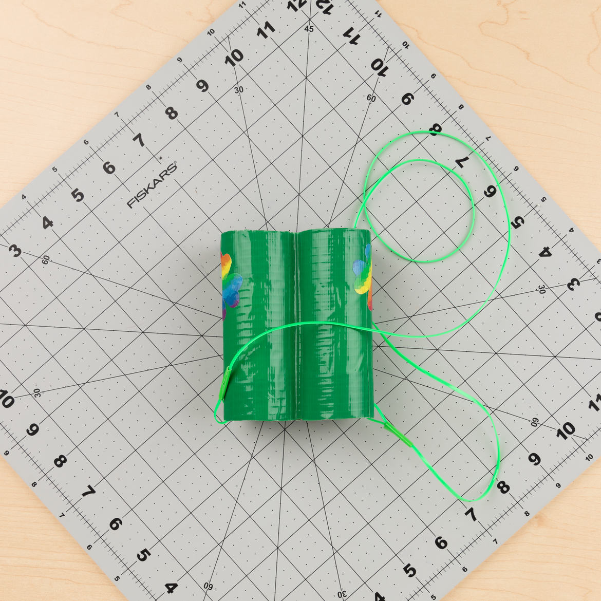 holes punched in the side of each roll, then string run through each to create a lanyard