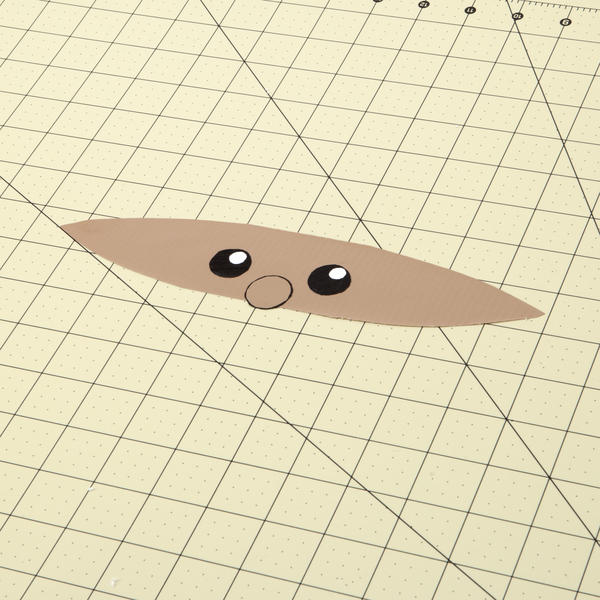 Santa's face assembled by placing the eyes and nose on the face piece