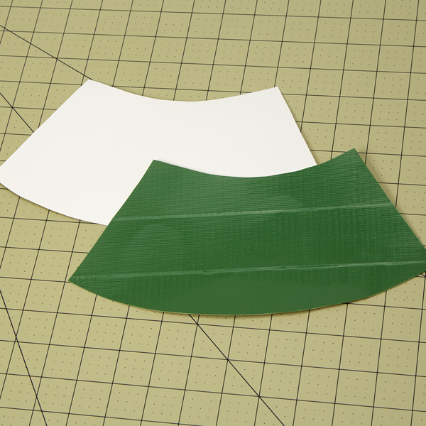 Arch shape cut out of a piece of poster board, then covered in green Duck Tape